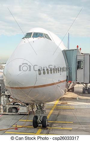 Stock Photography of Jet bridge docked to the plane at the airport.