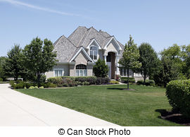 Stock Photo of Large brick home with arched entry.