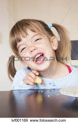 Stock Photograph of Portrait of little girl eating cake with open.