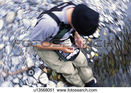 Stock Photography of Fisherman Baiting A Hook u13568051.