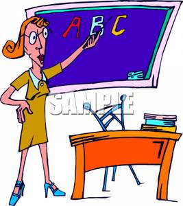 A Teacher Writing The Alphabet On A Blackboard.