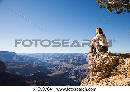 Stock Photography of USA, Arizona, Grand Canyon, woman sitting on.
