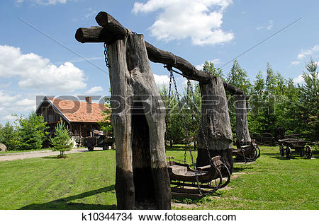 Stock Photo of Retro swing carriage hang on chains on tree trunk.
