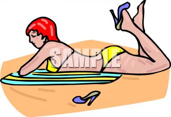 Woman Laying on a Beach Towel in the Sand.