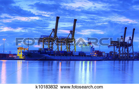 Stock Photo of Container Cargo freight ship with working crane.