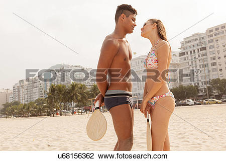 Stock Photo of Young couple about to kiss on Copacabana Beach, Rio.