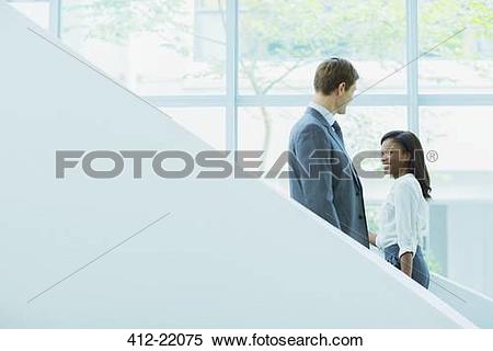Stock Image of Business people crossing paths on staircase 412.