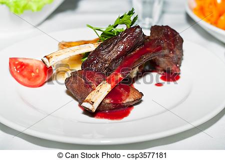 Stock Photography of Roasted Rack of Lamb herb crusted on a white.