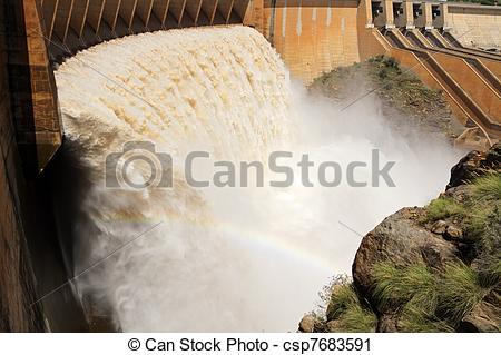 Stock Photography of Dam wall with open sluice gates.