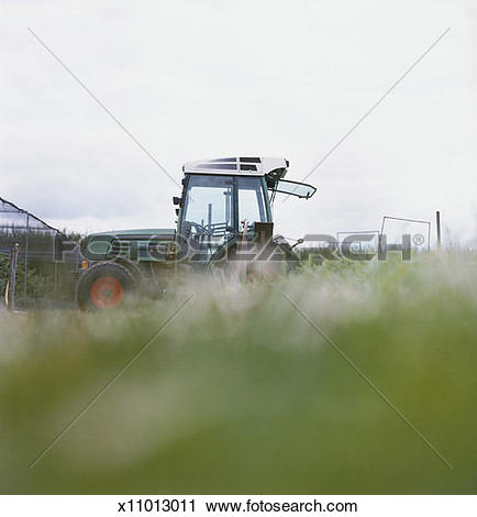 Stock Photography of Ground Level View of a Parked Tractor.