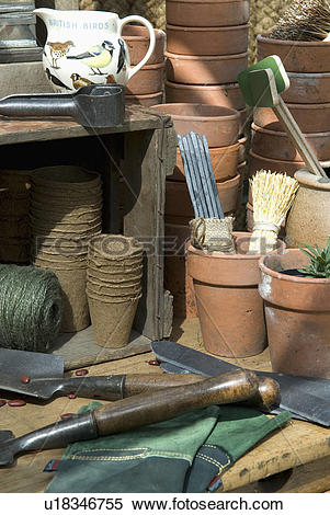 Stock Image of Greenhouse bench with terracota pots and sundry.