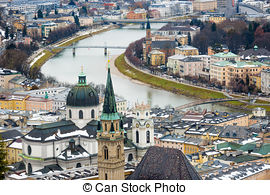 Stock Images of Woman tourist against aerial view over Salzburg.