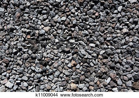 Stock Photo of Black volcanic lava stones pattern texture.