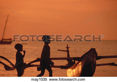 Stock Image of Silhouetted children passing by a traditional.