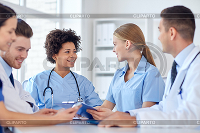 Group of happy doctors meeting at hospital office.