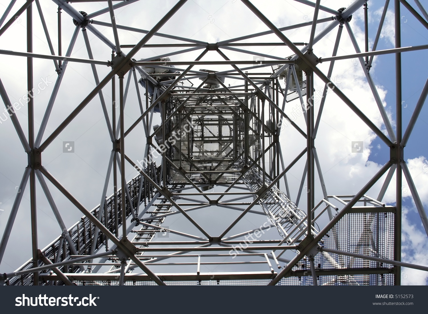 Metal Structure Of Antenna Mast Under Sky With Clouds Stock Photo.