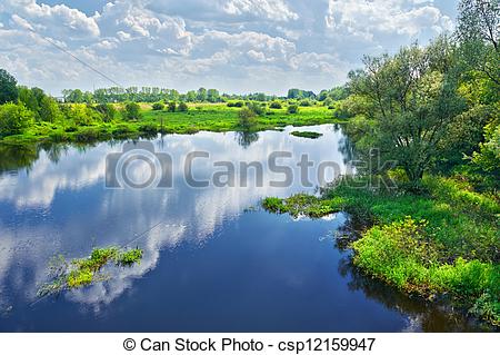 Stock Photo of Spring landscape with Narew river and clouds on the.