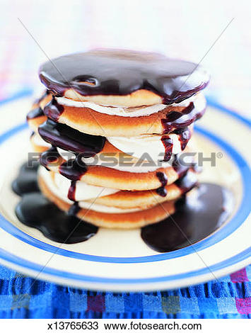 Stock Photo of Pile of Pancakes With Ice Cream and Chocolate Sauce.