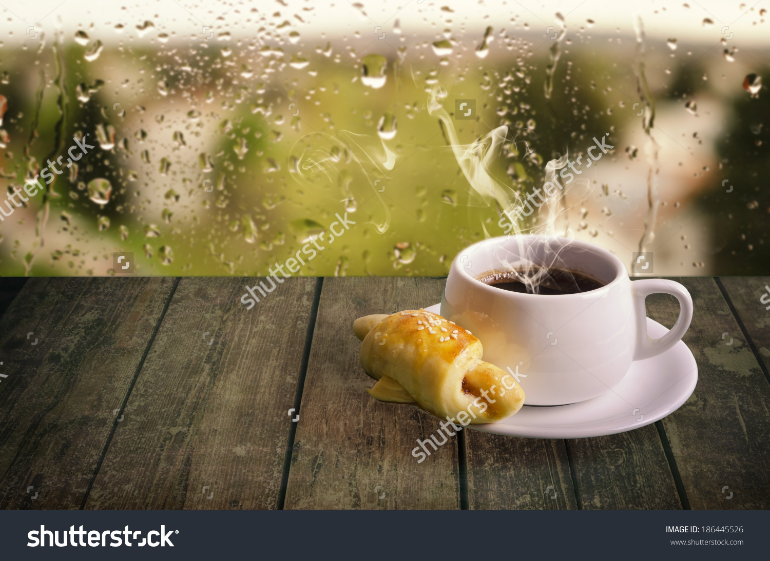 Steaming Coffee Cup On Rainy Day Stock Photo 186445526.