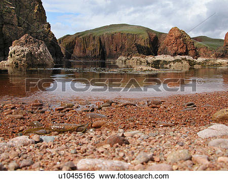 Stock Image of Scotland, Shetland, Muckle Roe, Red stone shoreline.