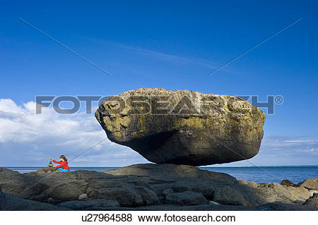 Pictures of Child balancing rocks on beach, Balance Rock, Graham.