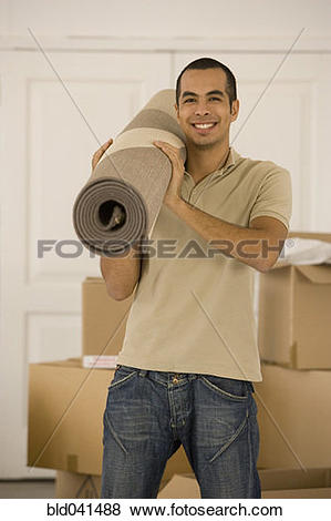 Pictures of Man holding rolled rug in new house bld041488.