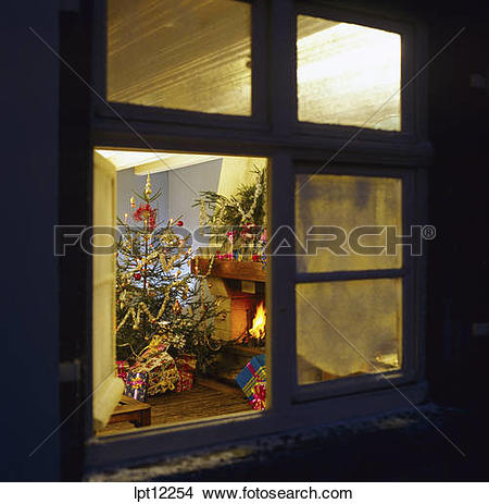 Stock Photo of CHRISTMAS PRESENTS UNDER THE TREE AND FIREPLACE.