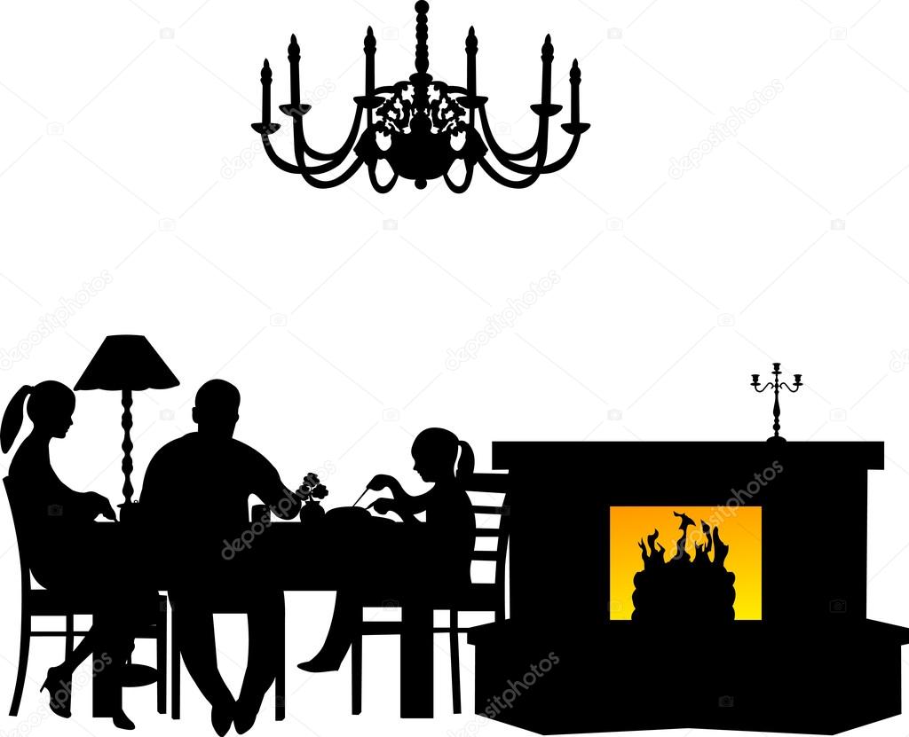 Family having their dinner at the table next to the fireplace in.