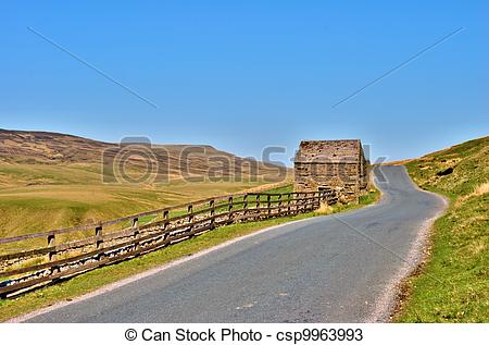 Stock Photos of Country road and old stone barn.