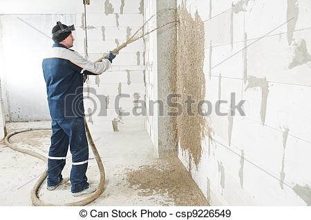 Stock Photography of Plasterer at stucco work with liquid plaster.