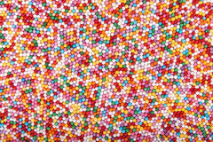 Colored Sugar Pellets Background Stock Photo.