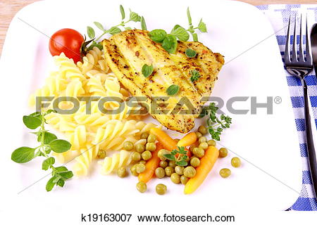 Picture of Grilled turkey steak with noodles peas, carrots, tomato.