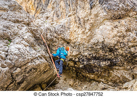 Stock Images of Woman climbing on metal ladder in via ferrata.