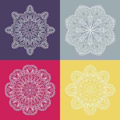 Four beautiful circular ornament on a colored background.
