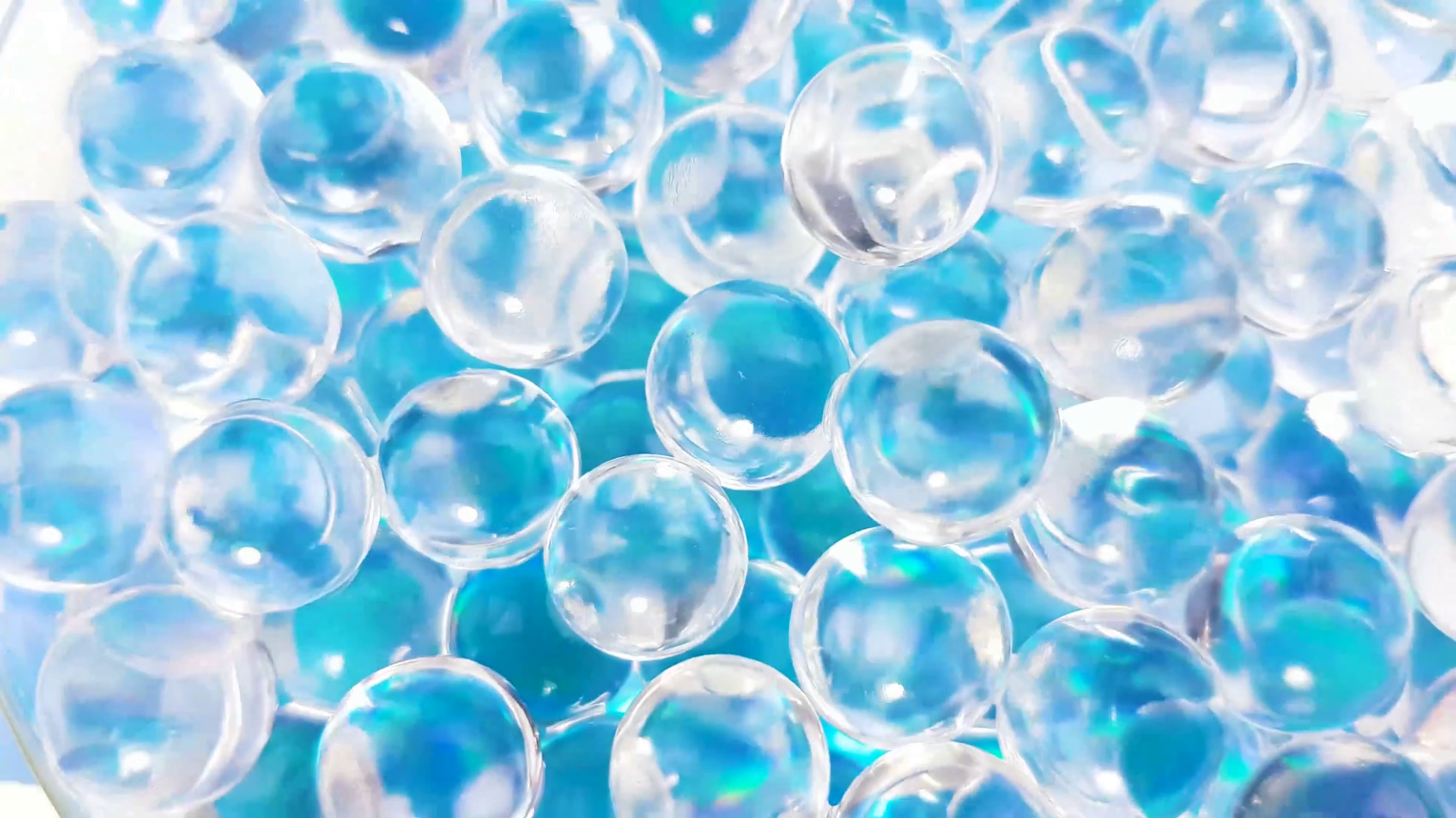 Water blue gel balls. Crystal liquid ball with reflection. Close up macro.  Stock Video Footage.