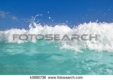Stock Images of blue turquoise wave caribbean sea water foam.