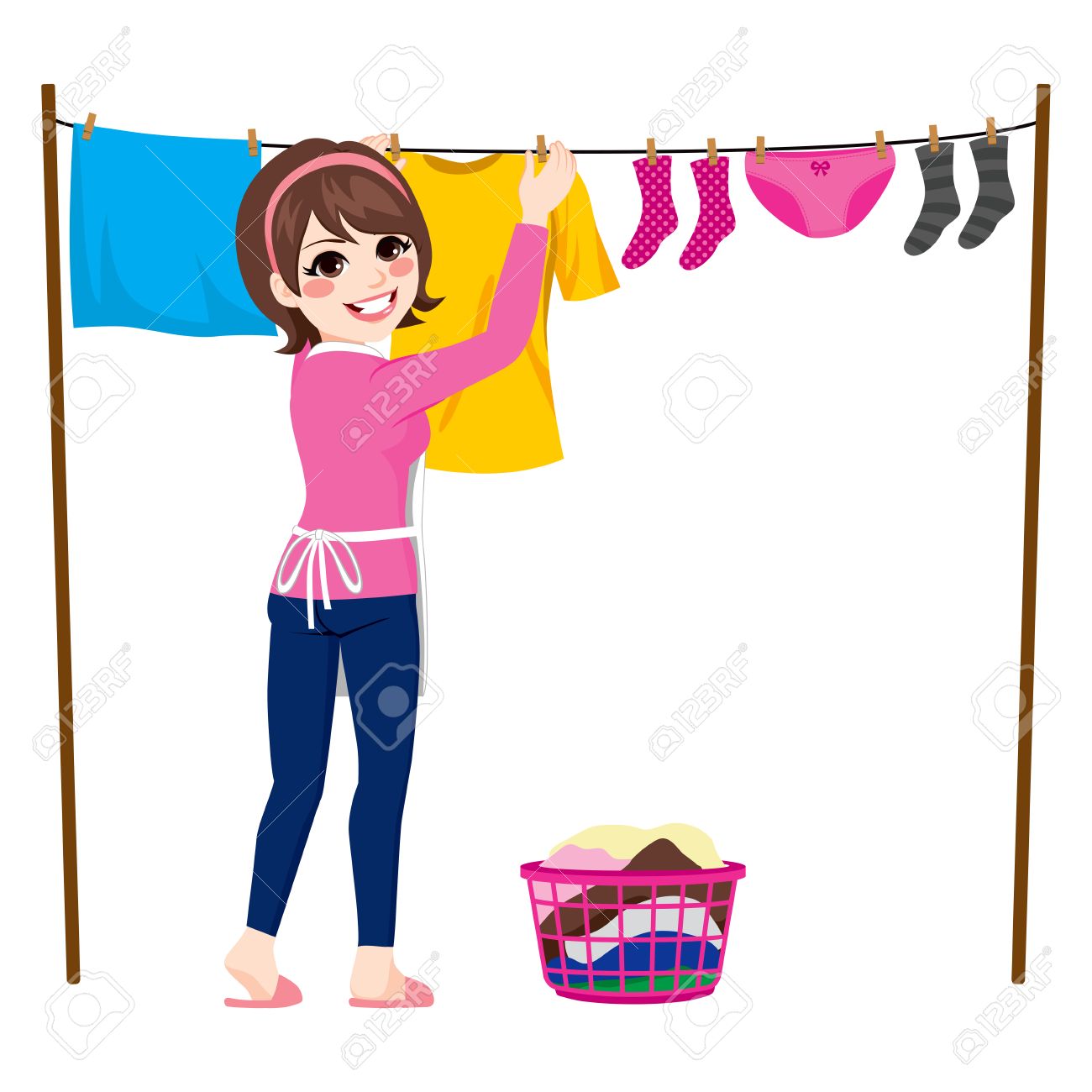 Happy young woman hanging wet clothes out to dry.