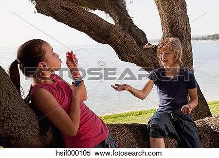 Stock Image of Croatia, Zadar, Girls sitting on tree trunk and.